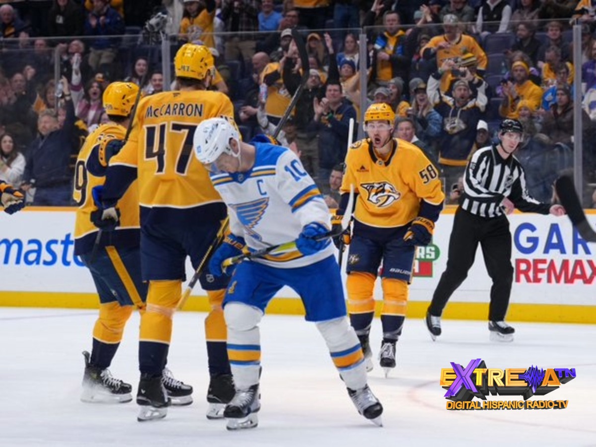 Michael McCarron (#47) de los Predators lucha por la posición en el hielo frente a un jugador de los Blues.