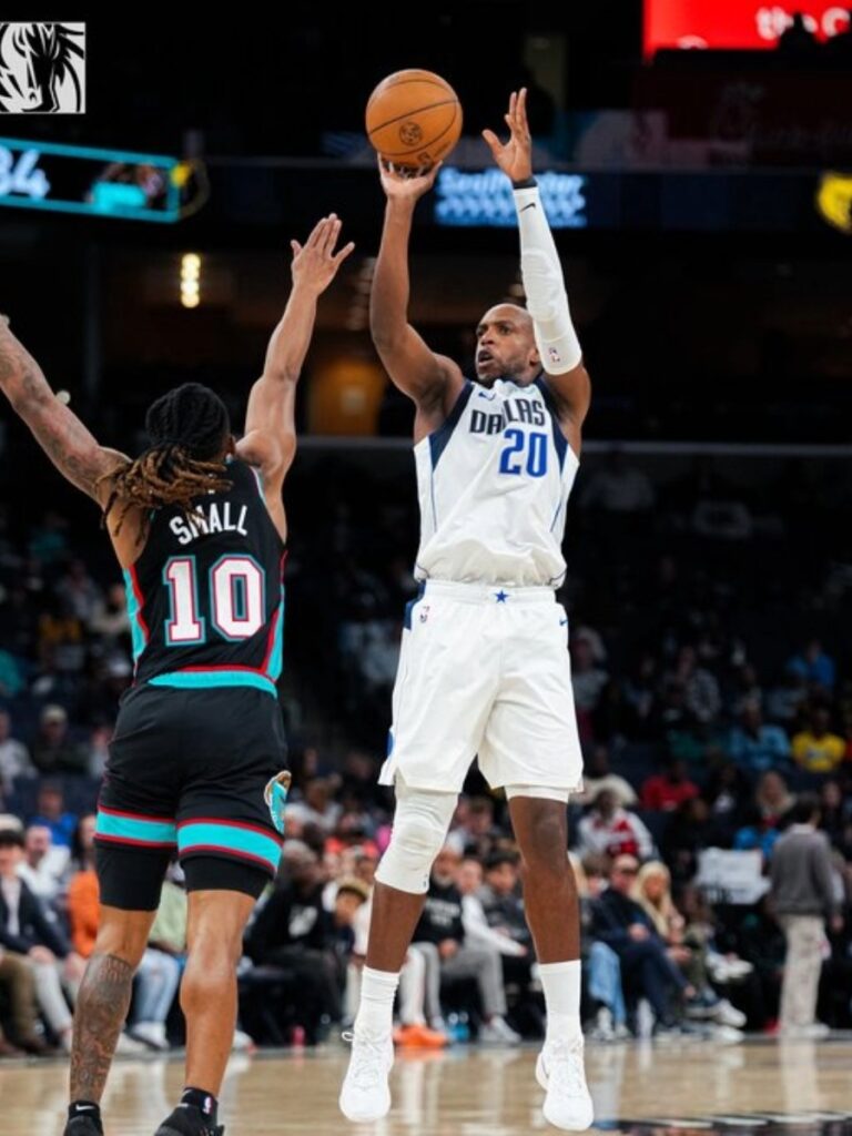 Khris Middleton de los Dallas Mavericks lanza sobre la defensa de Javon Small de los Memphis Grizzlies en el FedExForum durante la NBA 2026