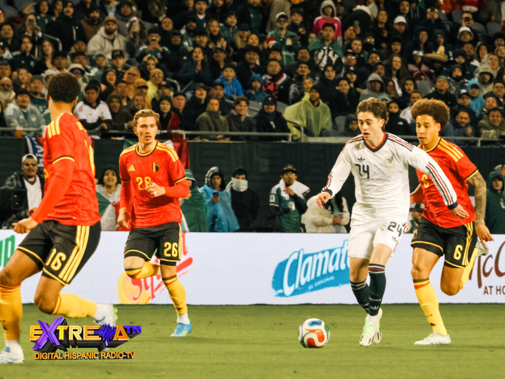 Brian Gutiérrez de México conduce el balón rodeado de jugadores de Bélgica en el Soldier Field de Chicago